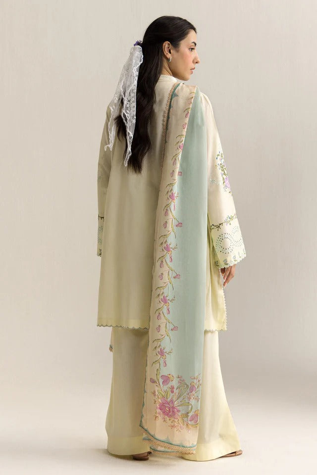 Woman wearing a traditional outfit with floral patterns on a plain background