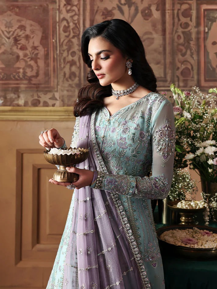 Woman in traditional attire holding a bowl in an ornate room