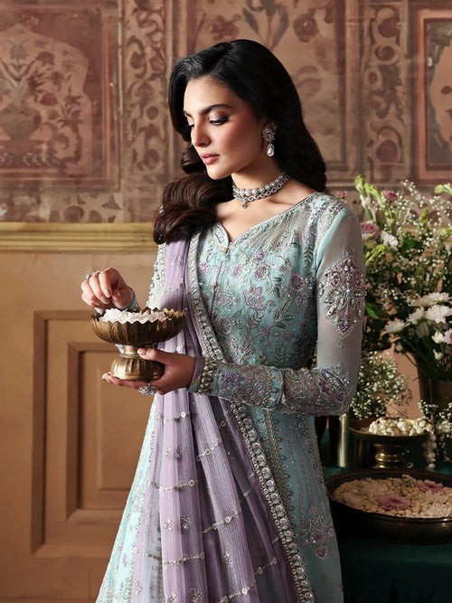 Woman in traditional attire holding a bowl in an ornate room