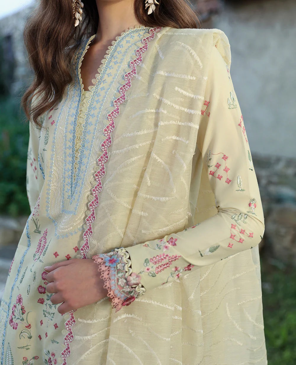 Light-colored embroidered traditional outfit with floral patterns.