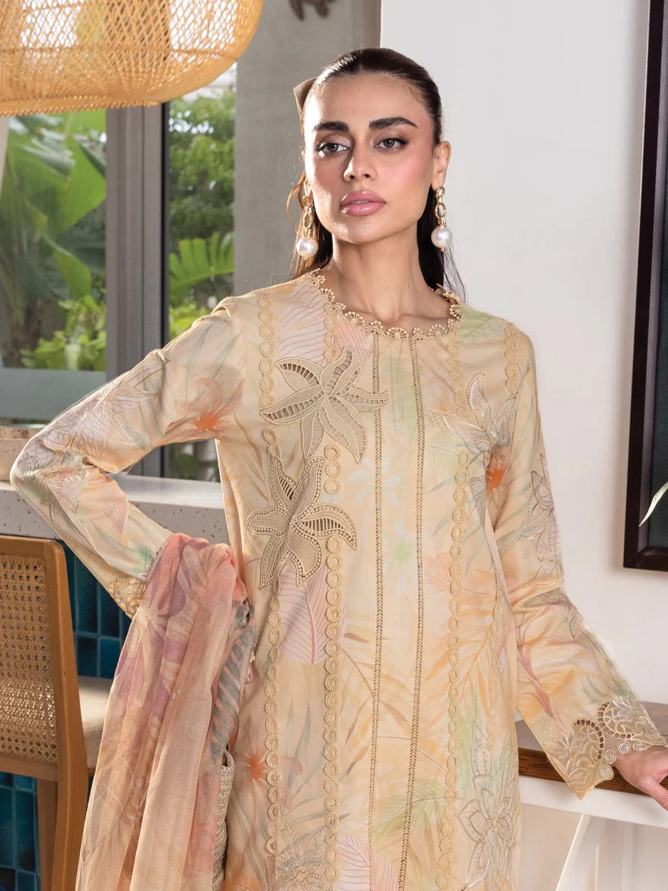 A woman models a traditional long-sleeve kurta in a light beige or cream color with delicate floral embroidery and lace detailing, paired with a matching dupatta, set against an indoor background with a window and warm lighting.