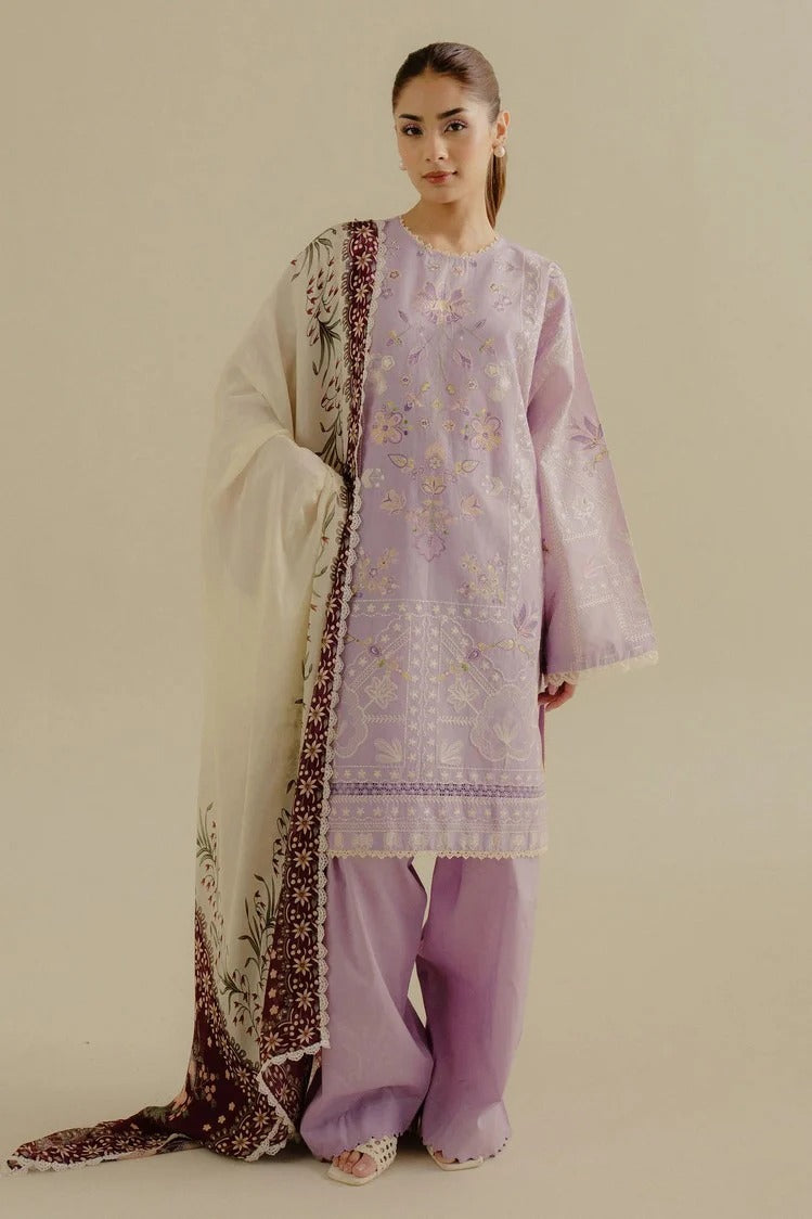 Woman wearing a lavender embroidered outfit with a matching dupatta on a beige background