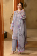 Woman wearing a floral embroidered outfit in a warm-toned room.