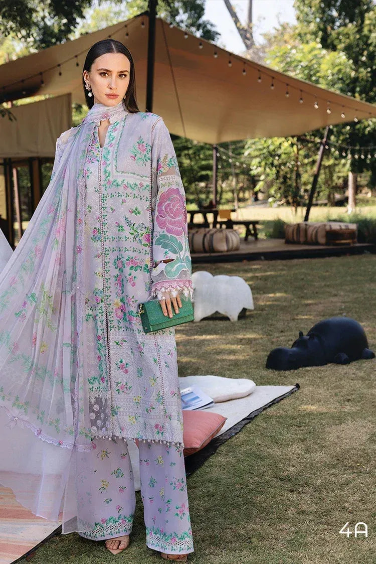 Woman in a floral outfit standing outdoors with tents and greenery in the background