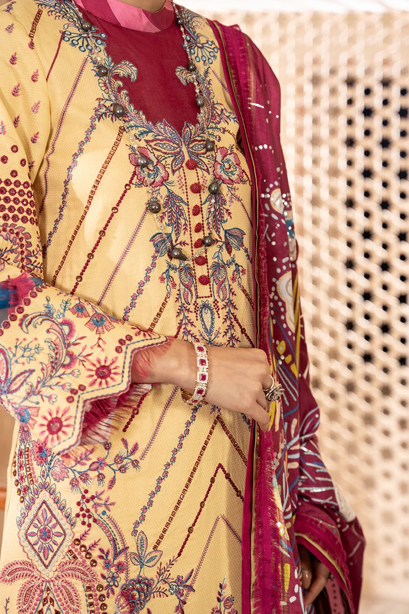 Traditional outfit with a yellow and red patterned dress and dupatta against a textured beige background