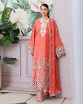 A woman models a peach-colored traditional kurta set with intricate white and silver embroidery, featuring a matching dupatta, set against a light pink wall with a floral print and potted plants.