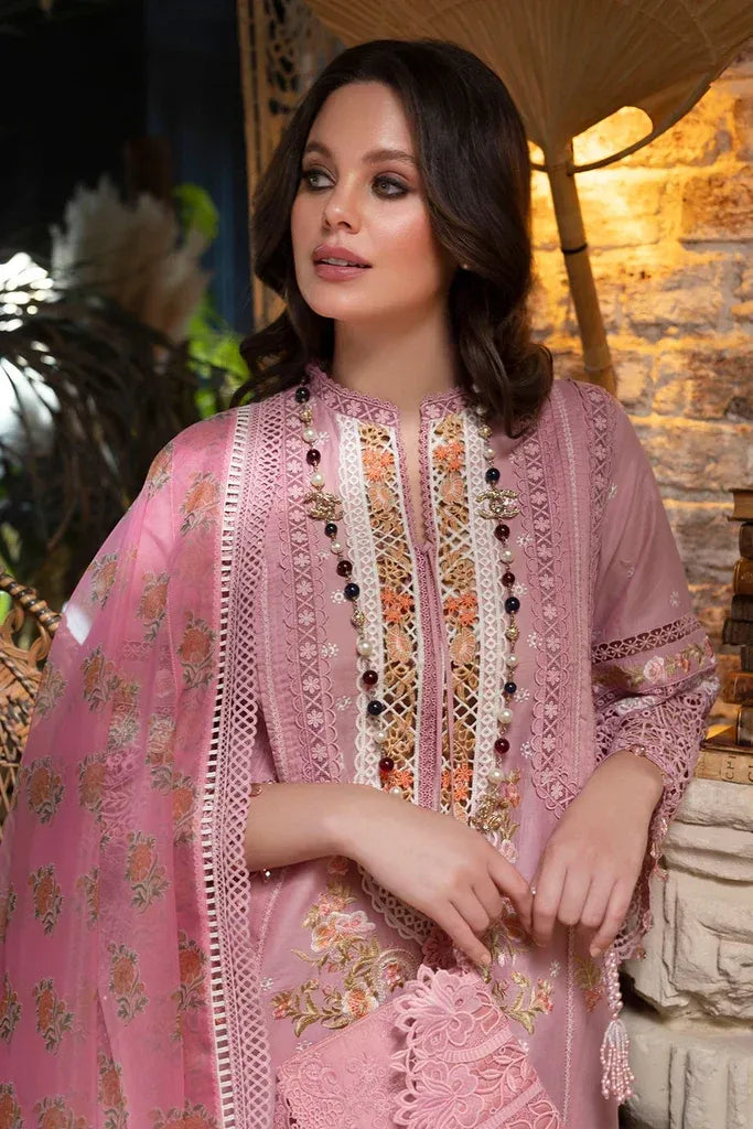 Woman wearing a pink embroidered traditional outfit with a blurred background