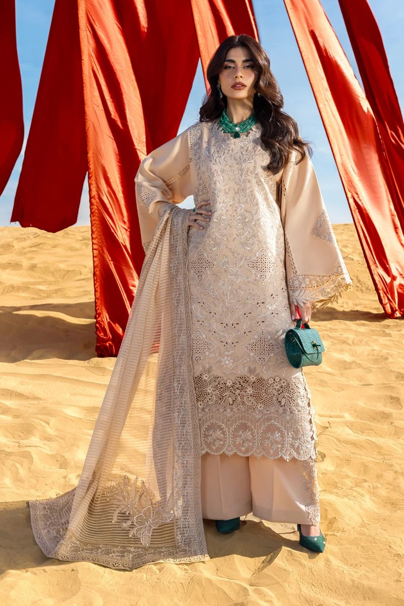 Woman in a beige embroidered outfit standing in a desert with red fabric in the background