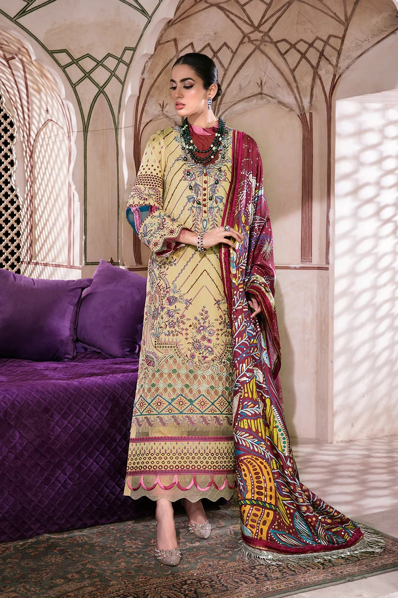 Woman in traditional embroidered outfit with a colorful dupatta in an ornate room.