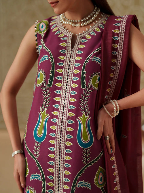 Person wearing a vibrant purple traditional outfit with intricate patterns and jewelry.