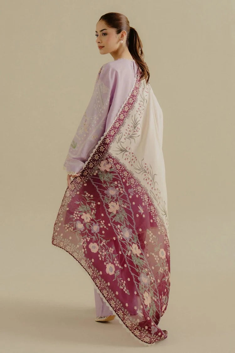 Woman wearing a floral saree with a plain background