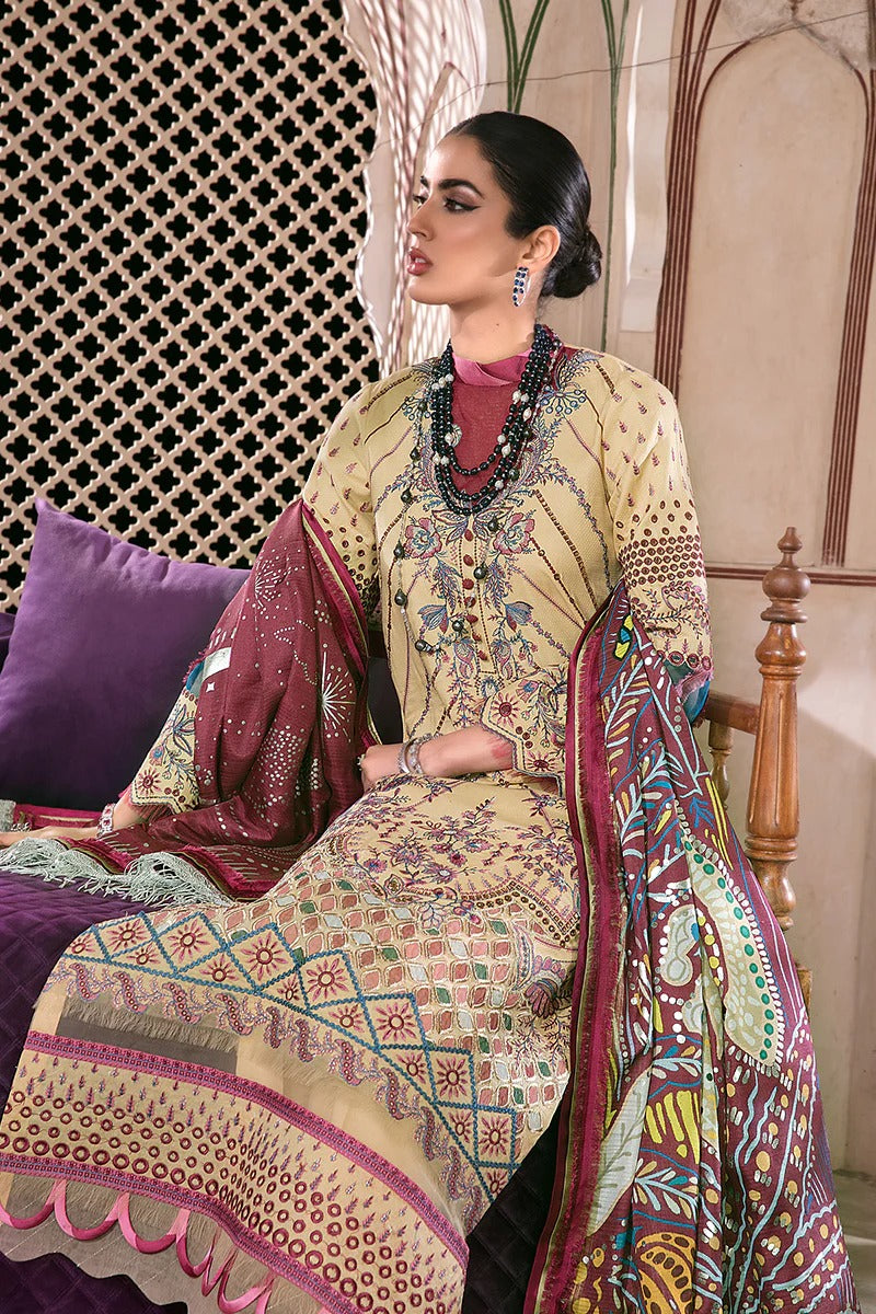 Woman in a traditional outfit with intricate patterns sitting on a chair.