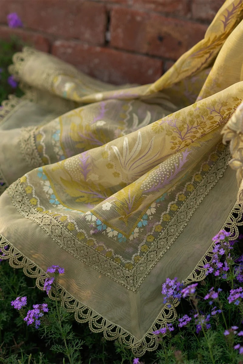 Decorative tablecloth with floral patterns and lace trim on a brick surface with flowers.