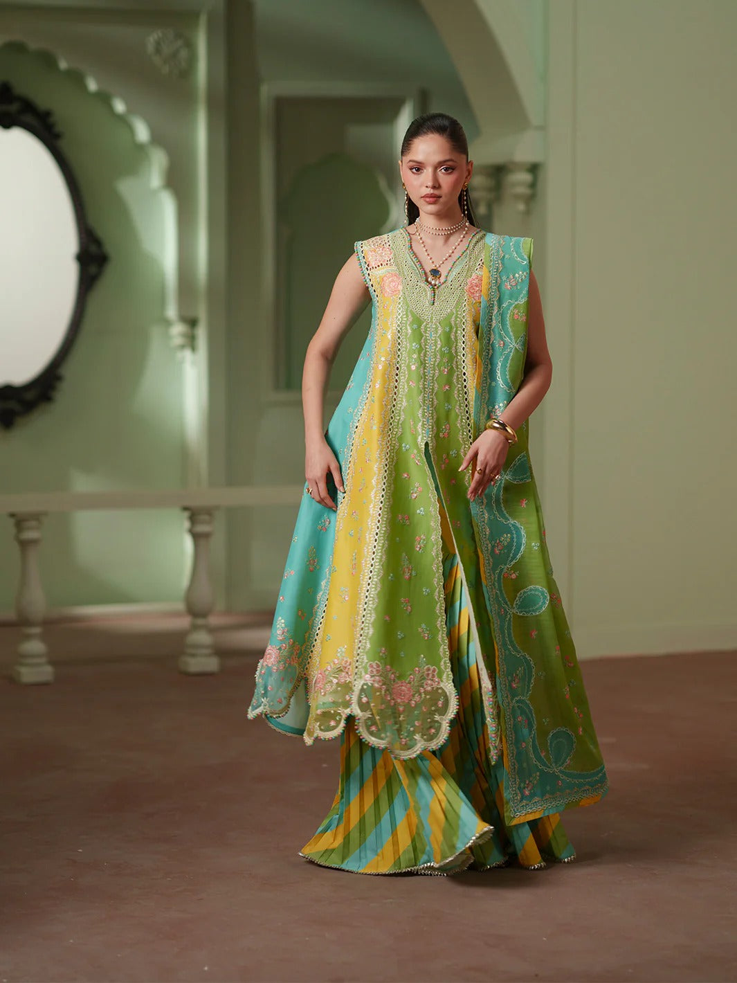 Woman wearing a colorful traditional outfit in an elegant interior setting