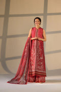 Woman wearing a red traditional outfit with white patterns on a neutral background
