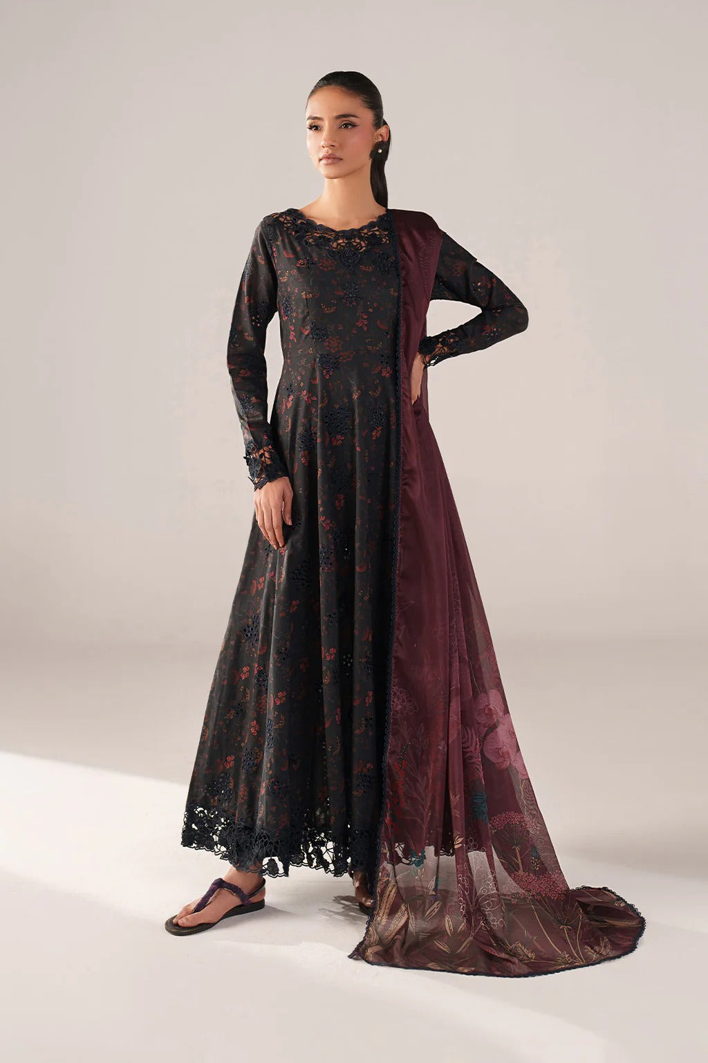 Woman wearing a black and red patterned dress on a white background
