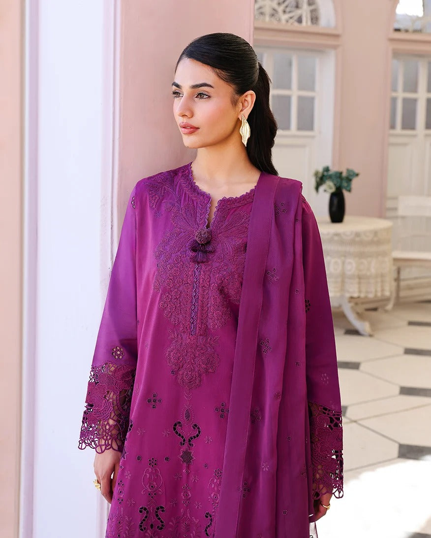 Woman wearing a purple embroidered outfit in an elegant indoor setting