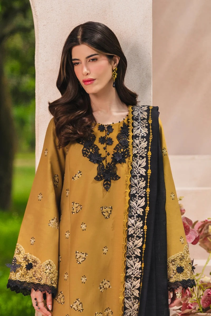 Woman wearing a mustard yellow and black embroidered outfit with a floral background