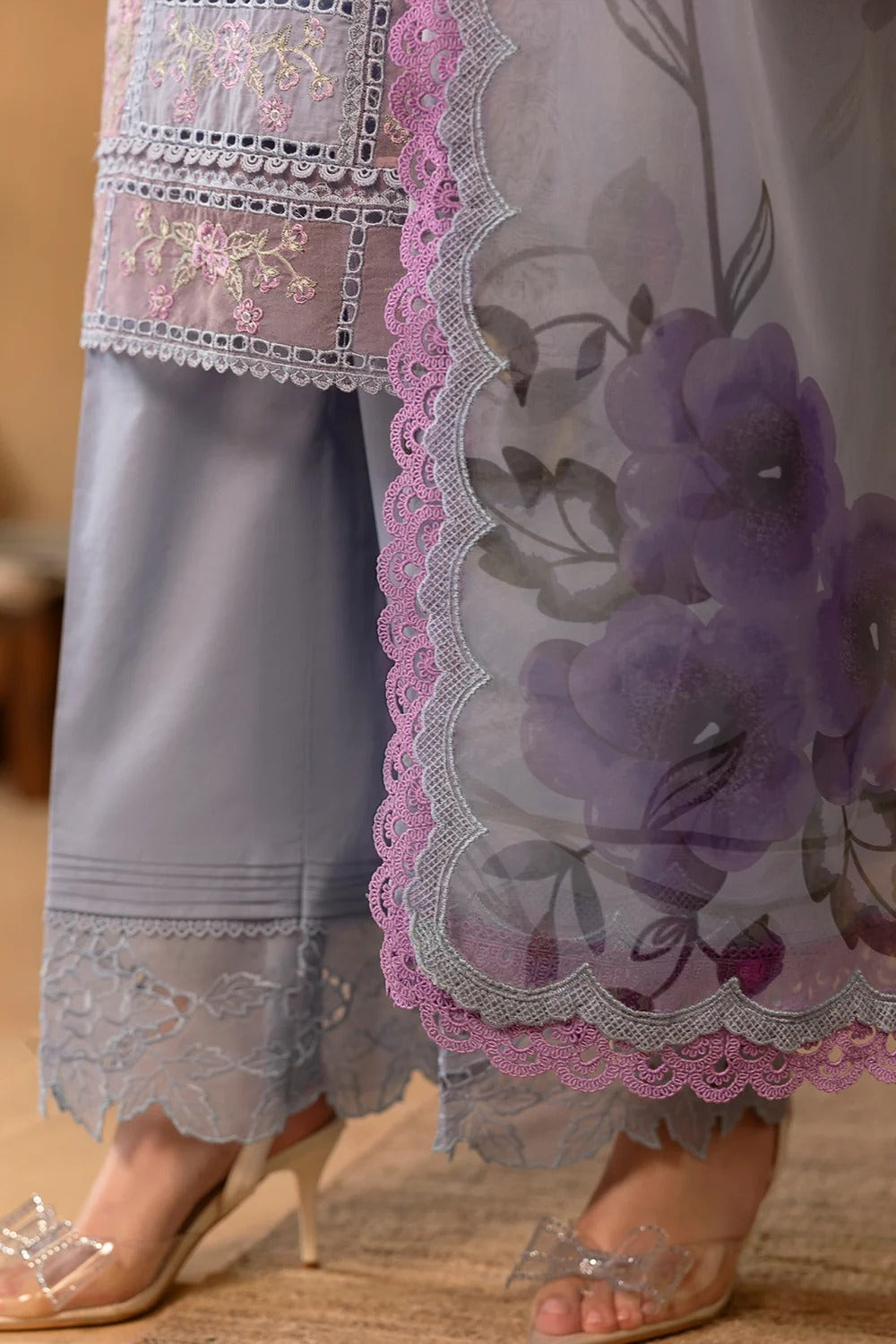 Lace-trimmed garment with floral design on a wooden floor