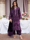 A woman models a traditional three-piece purple embroidered kurta set with matching pants and dupatta in an elegant outdoor event setting.