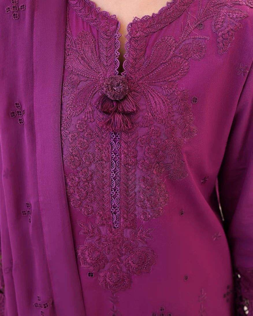 Close-up of a purple embroidered garment with intricate designs.