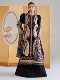 Woman wearing a black and gold embroidered traditional outfit with a wooden panel background