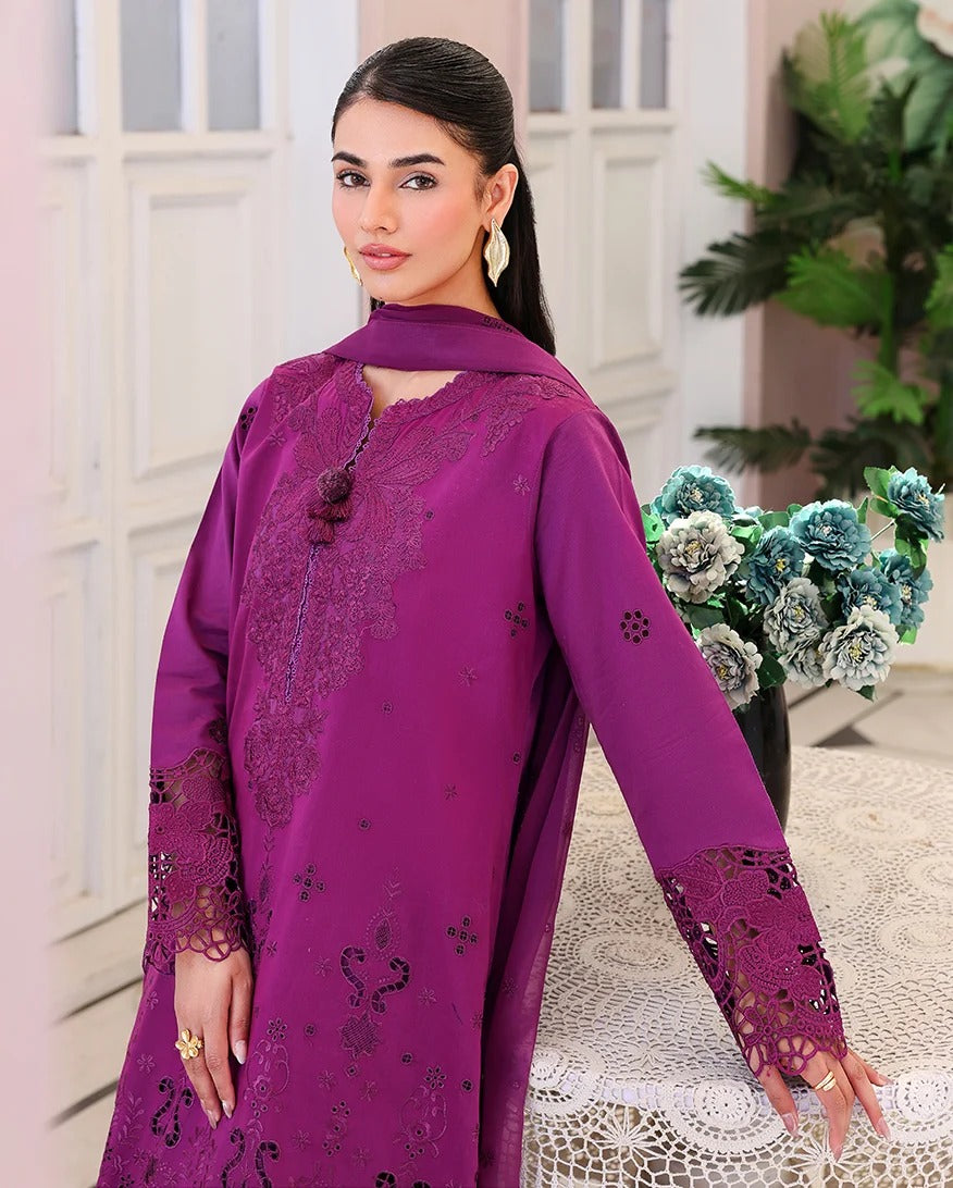 Woman wearing a purple embroidered outfit with a decorative background