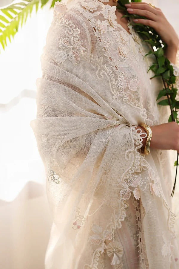 Close-up of a person wearing a white lace garment with greenery in the background