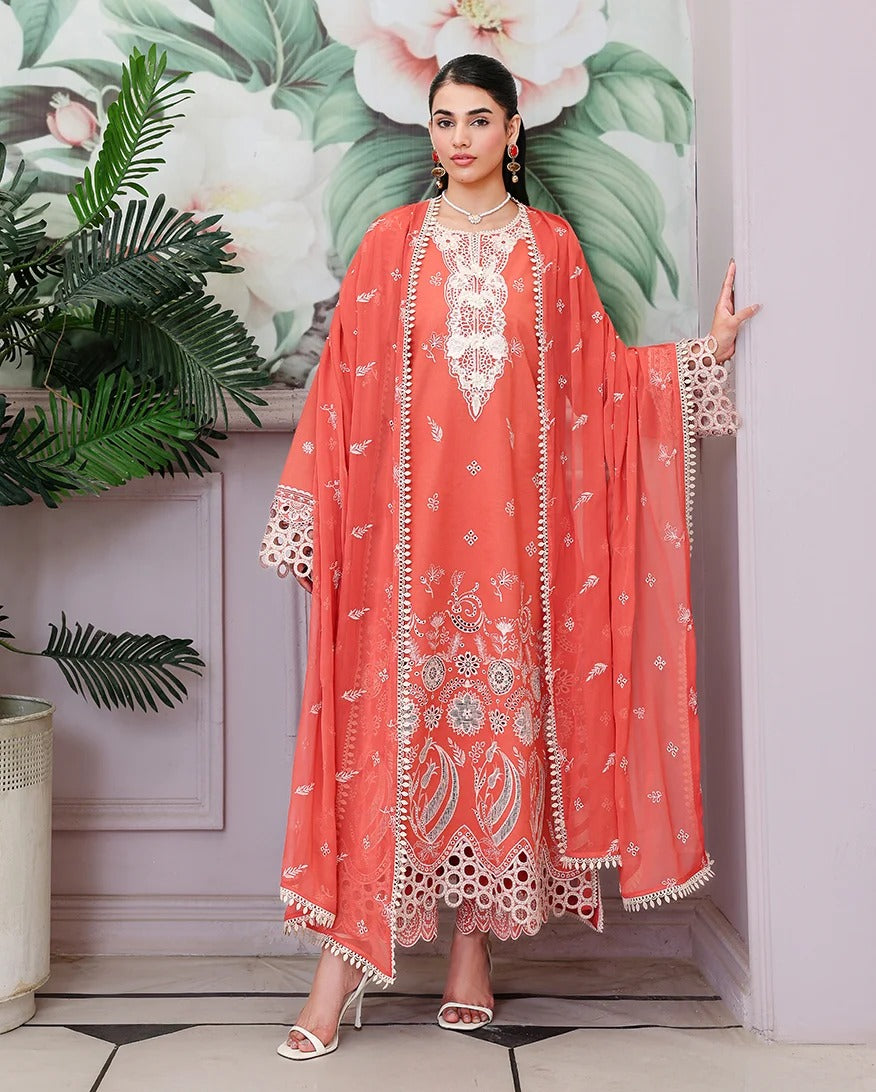 Woman wearing a coral embroidered outfit with a floral and leafy background