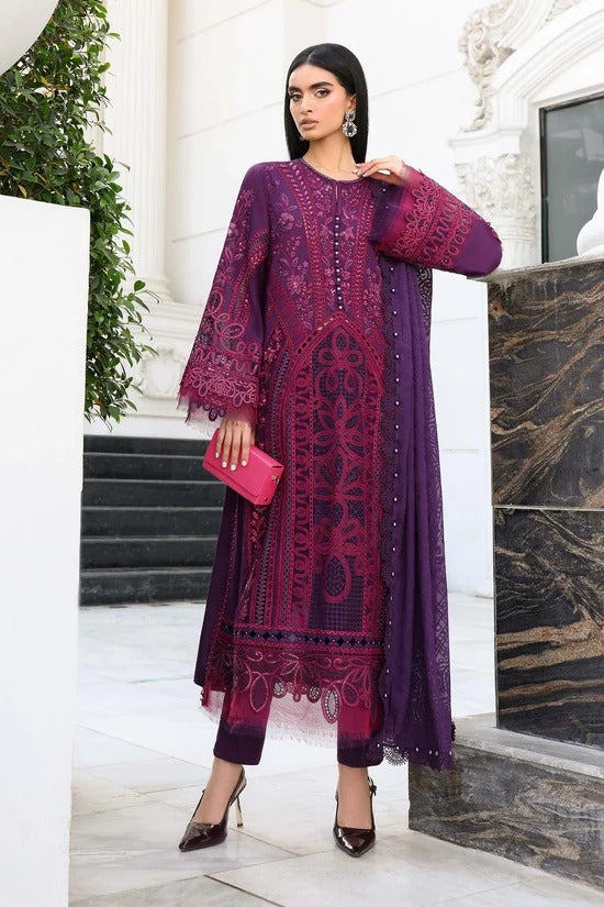 Woman in a purple embroidered outfit standing in an elegant interior setting.