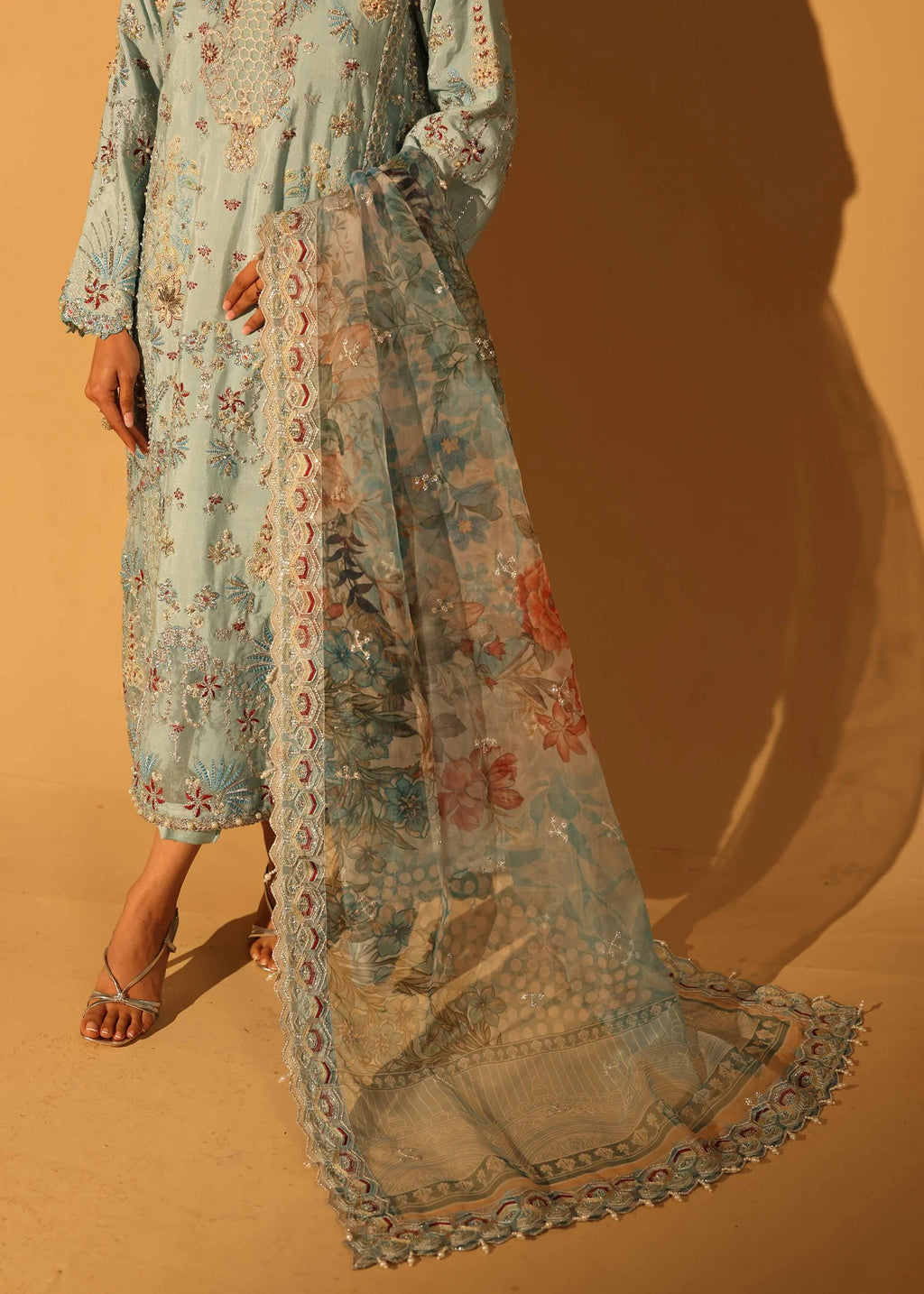 Long floral dress with a matching scarf on a sandy background