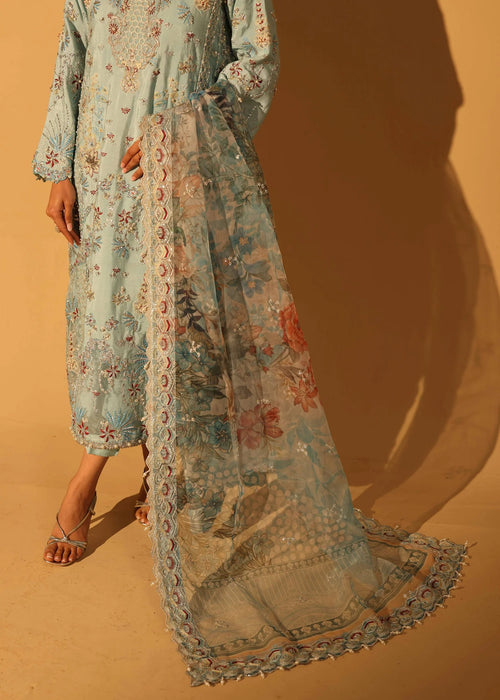 Long floral dress with a matching scarf on a sandy background