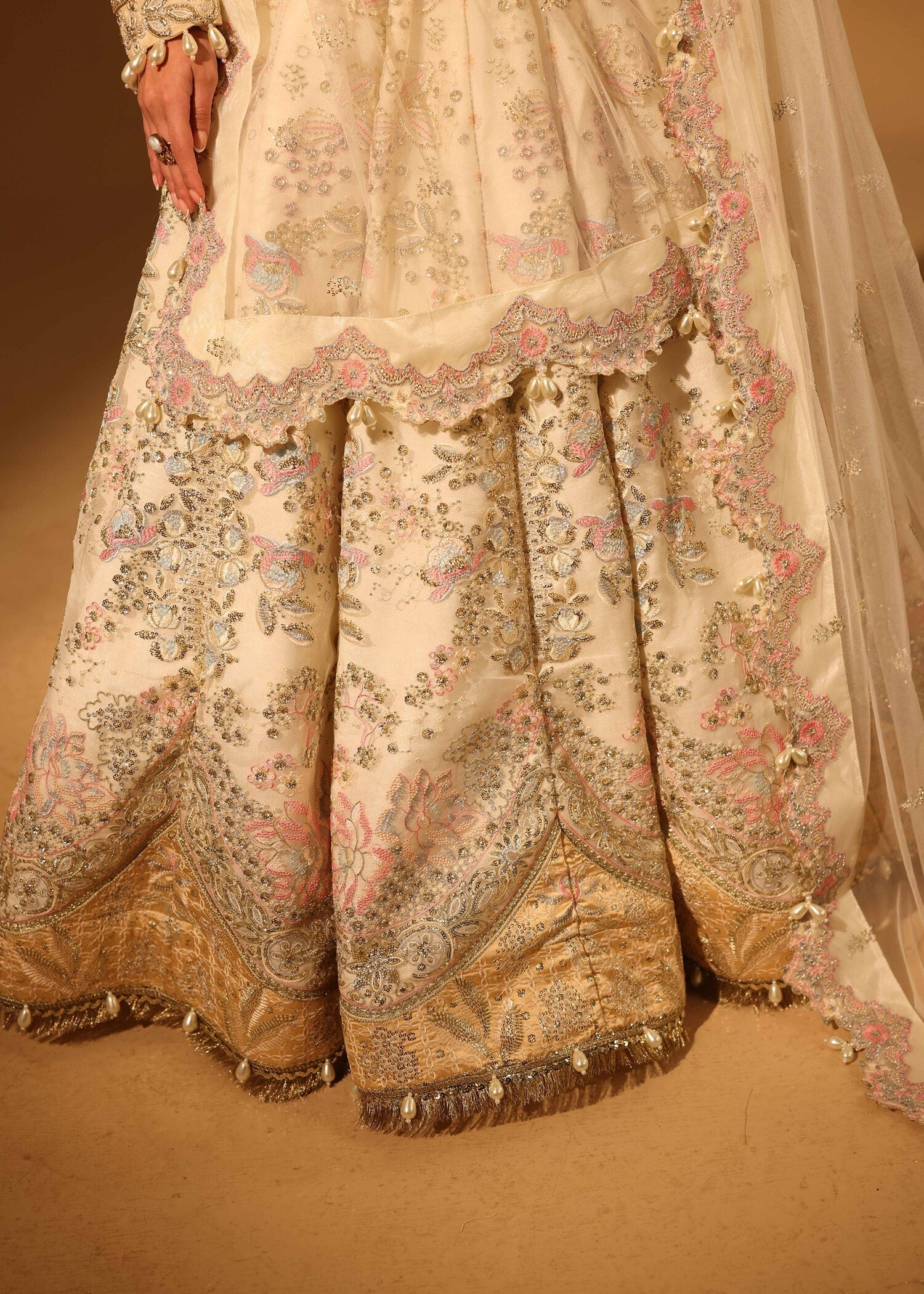 Traditional embroidered outfit with floral patterns on a beige background