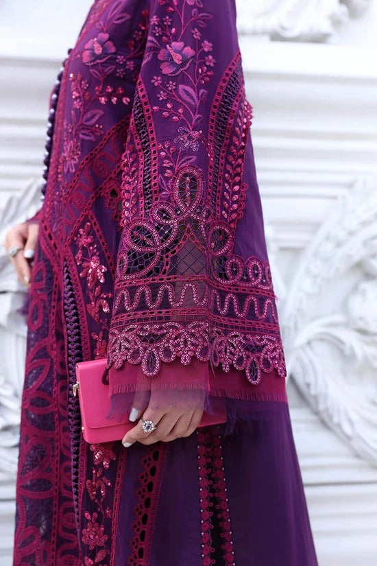 A close-up of a person wearing an ornate deep purple embroidered abaya with magenta floral embroidery and holding a bright pink clutch bag.