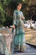 Woman in a floral outfit standing in front of a group of pelicans.