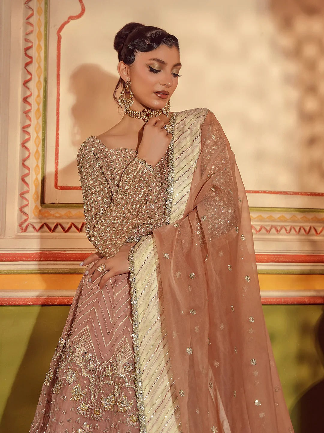Woman in traditional embroidered outfit with a decorative background