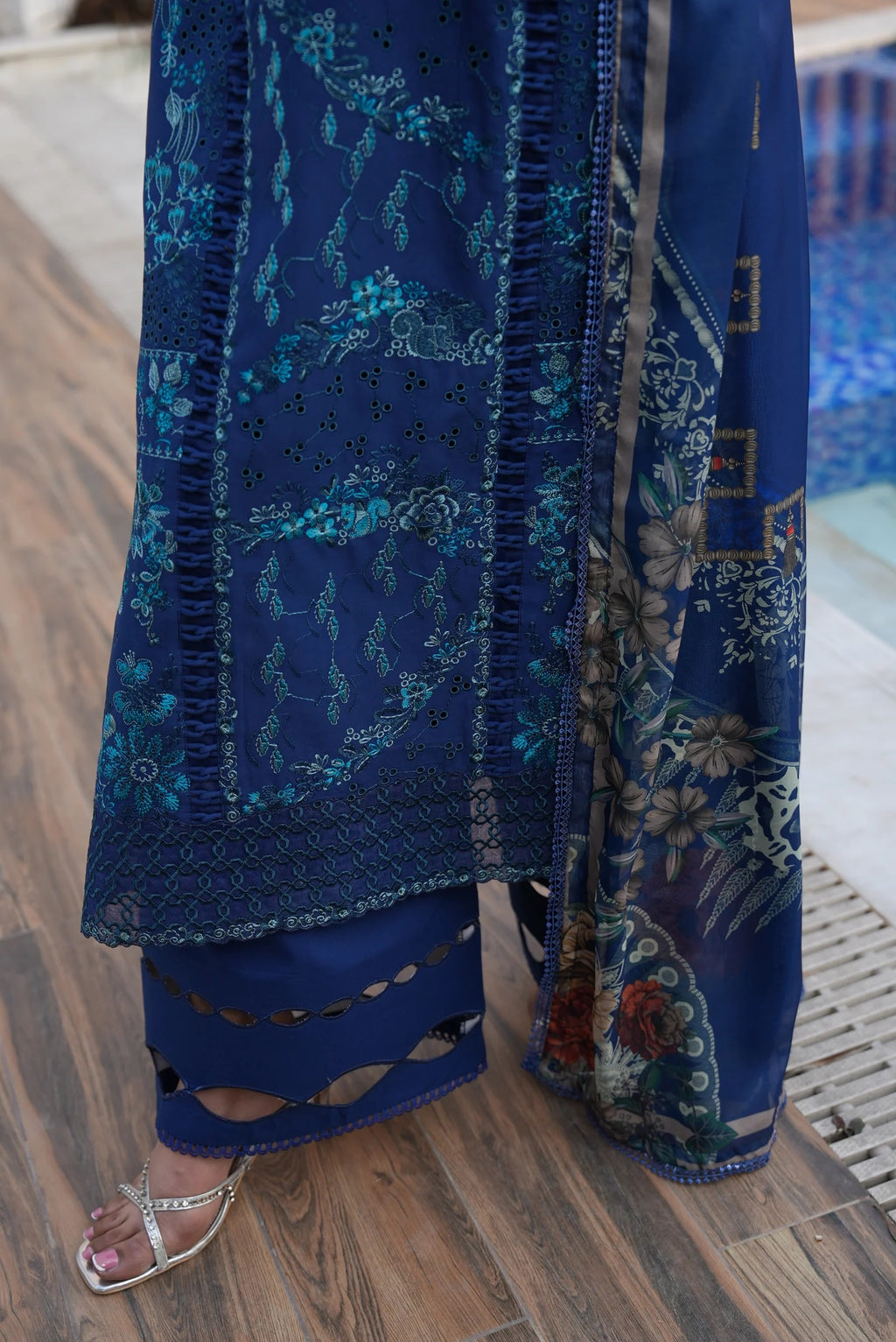 Blue embroidered garment on a wooden floor