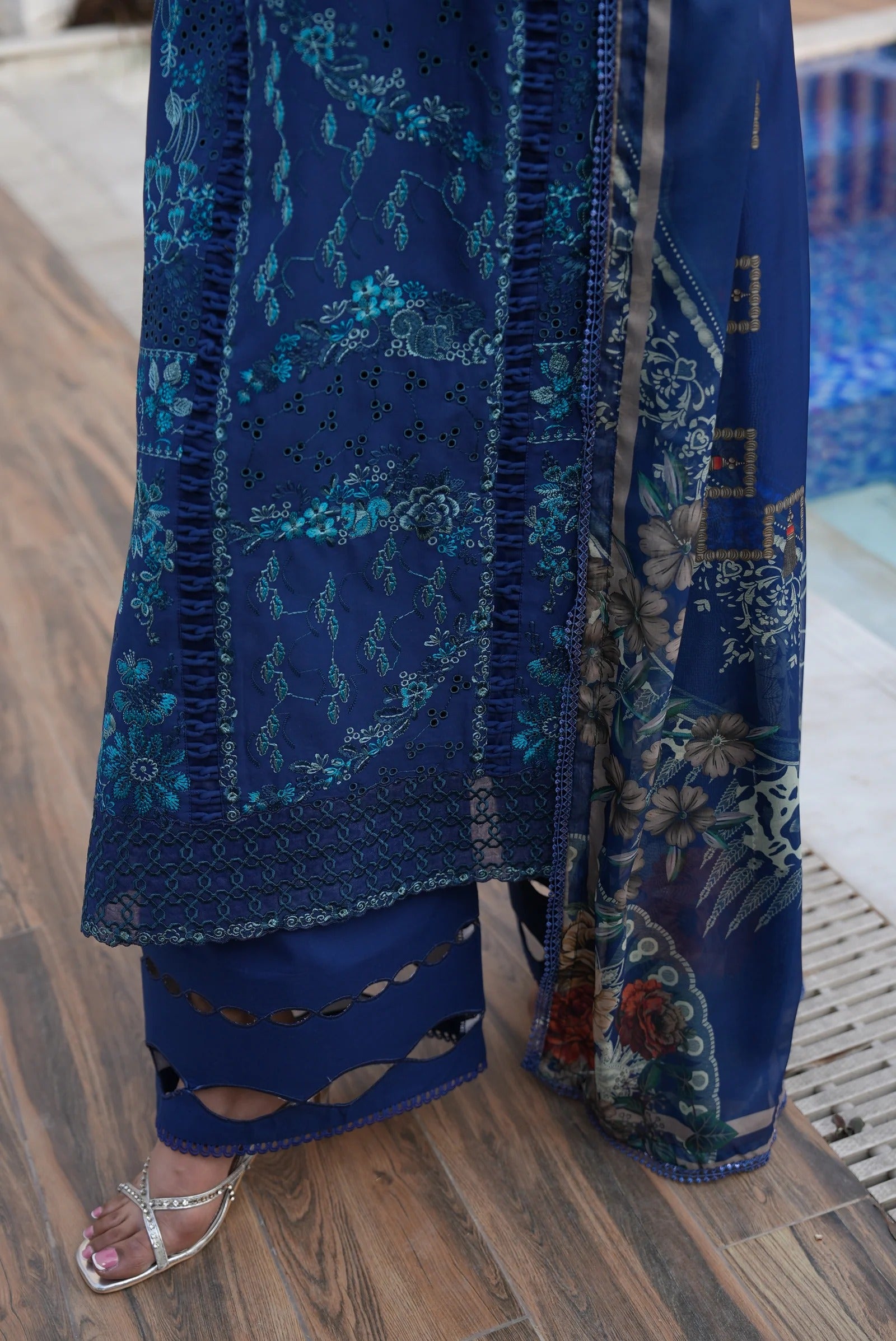 Blue embroidered garment on a wooden floor