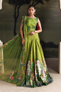 A woman models a green embroidered traditional gown with a matching sheer dupatta, featuring floral prints and a silver embellished neckline, set against a dark scenic backdrop.
