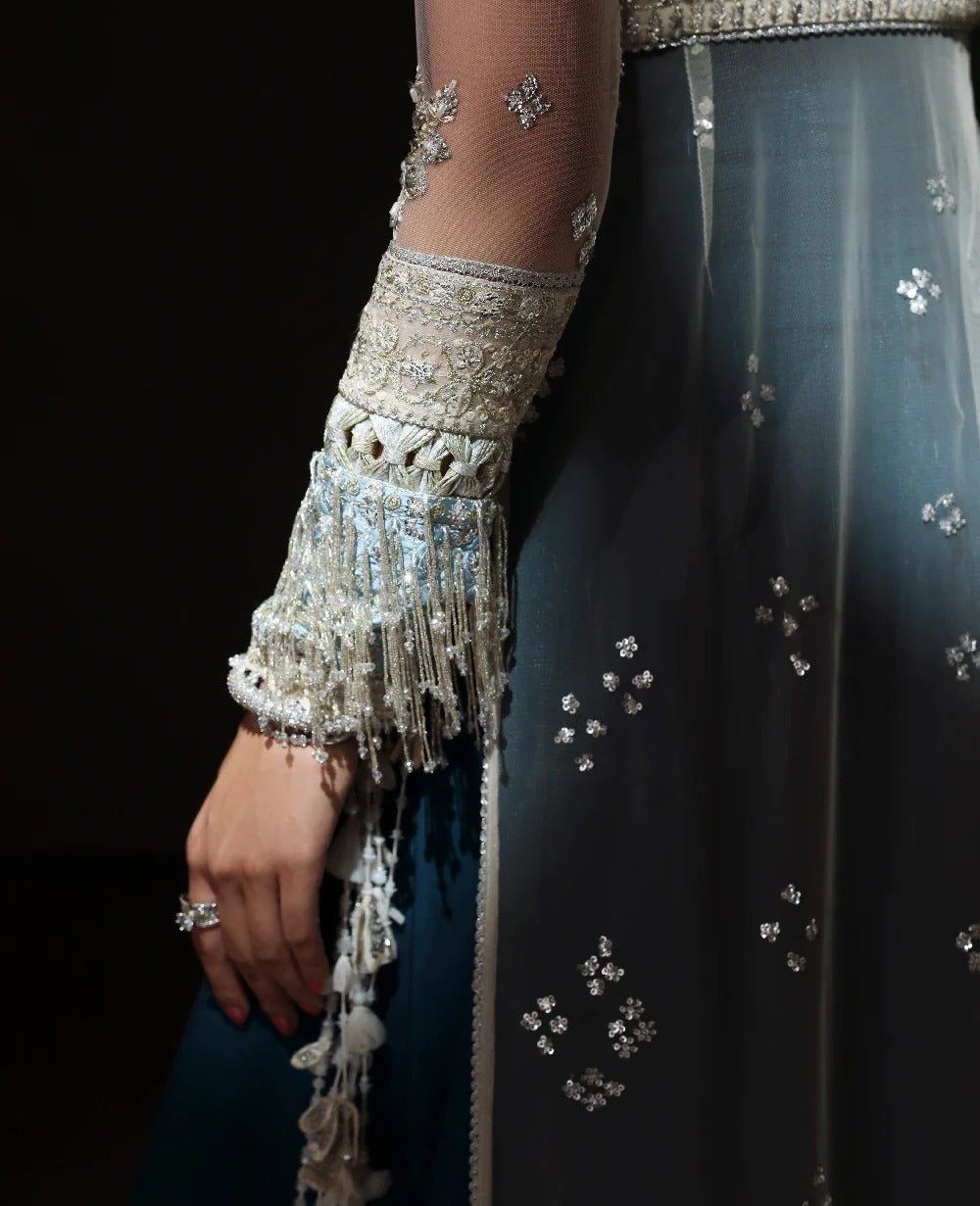 Elegant outfit with embroidered sleeves and a dark fabric background