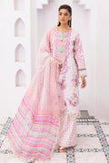 Woman wearing a pink and white traditional outfit with floral patterns in a decorative setting.