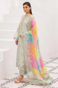 Woman in a colorful traditional outfit with a white staircase and patterned floor in the background