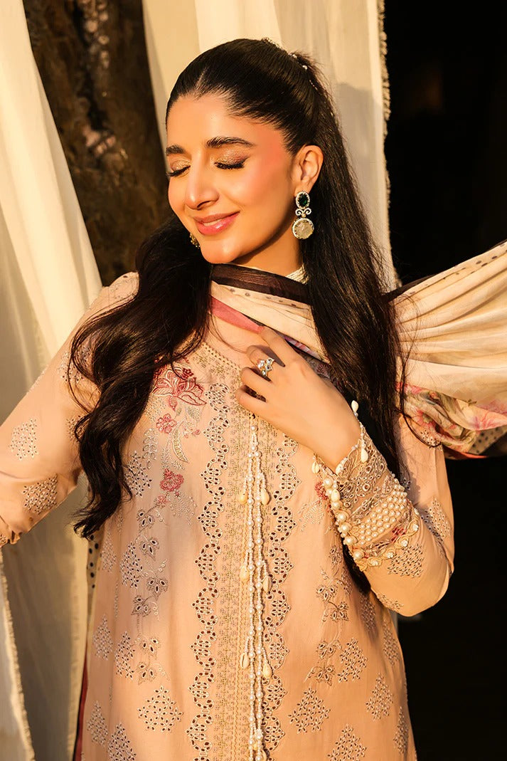 Woman wearing a traditional outfit with intricate designs and jewelry.