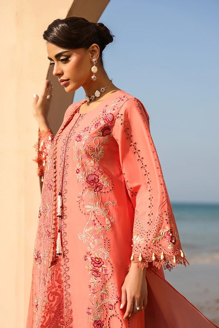 Woman wearing a coral embroidered outfit with a beach background