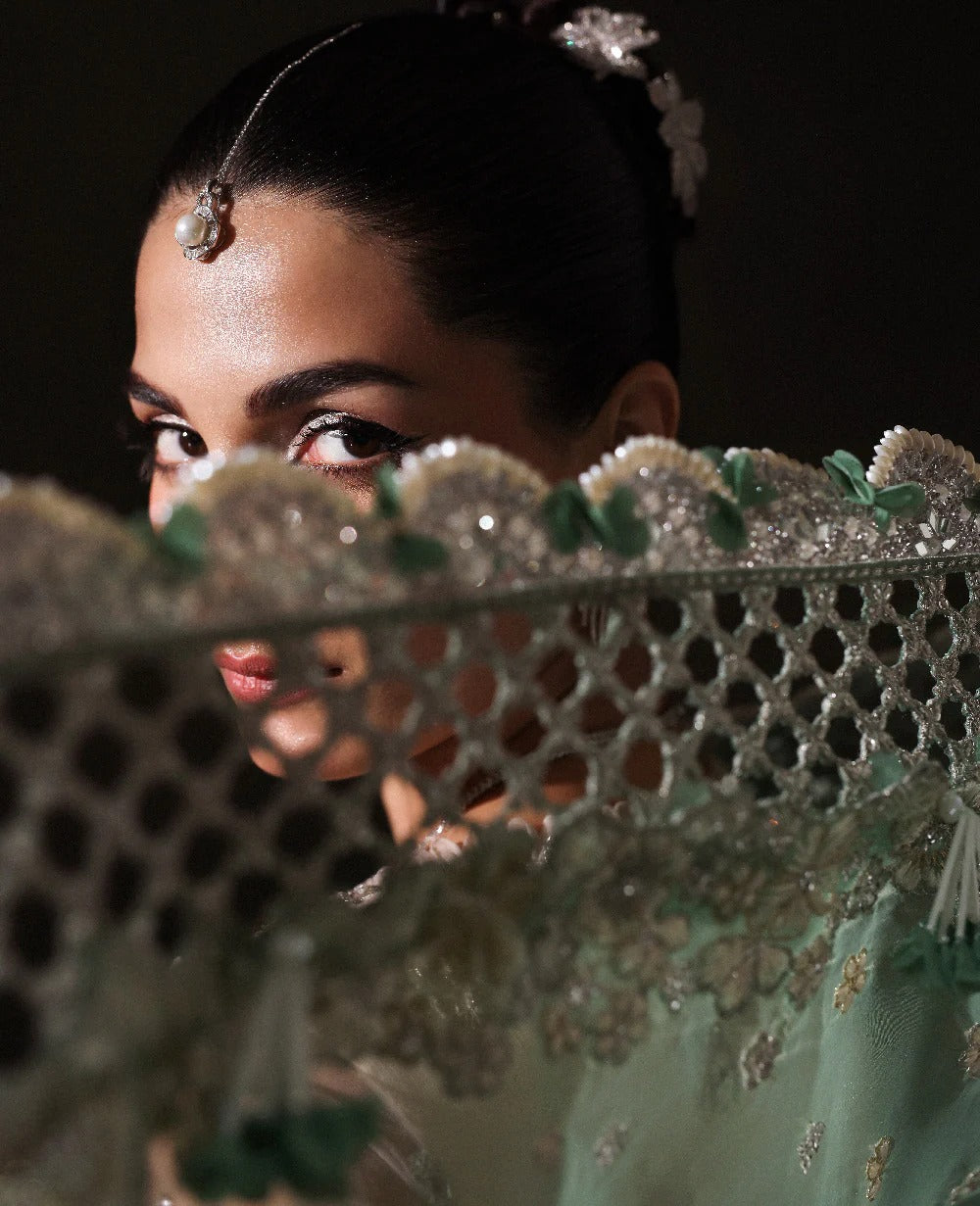 Woman wearing a traditional embroidered garment with intricate patterns