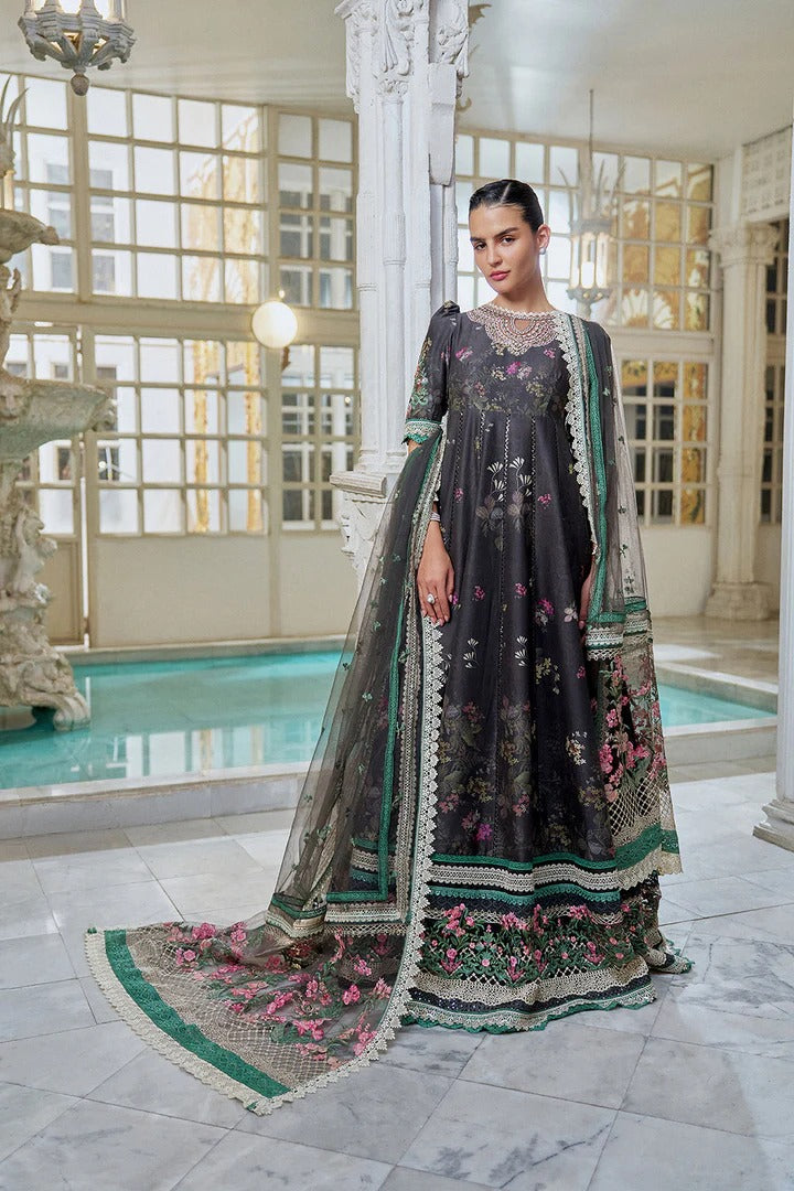 Woman in an elegant dress with floral patterns standing in a decorative interior setting.