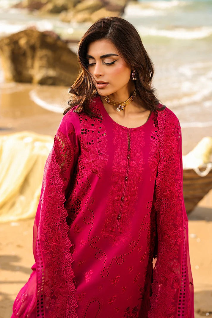 Woman wearing a pink lace dress standing outdoors with a blurred natural background