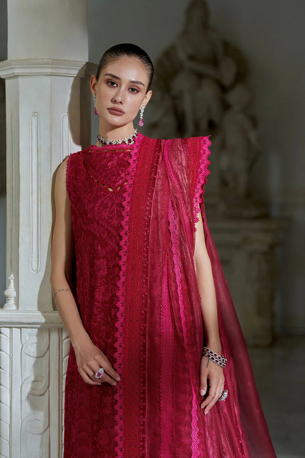 Woman wearing a red lace dress in an indoor setting