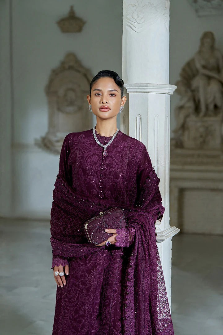 Woman in a purple dress standing in an elegant interior setting