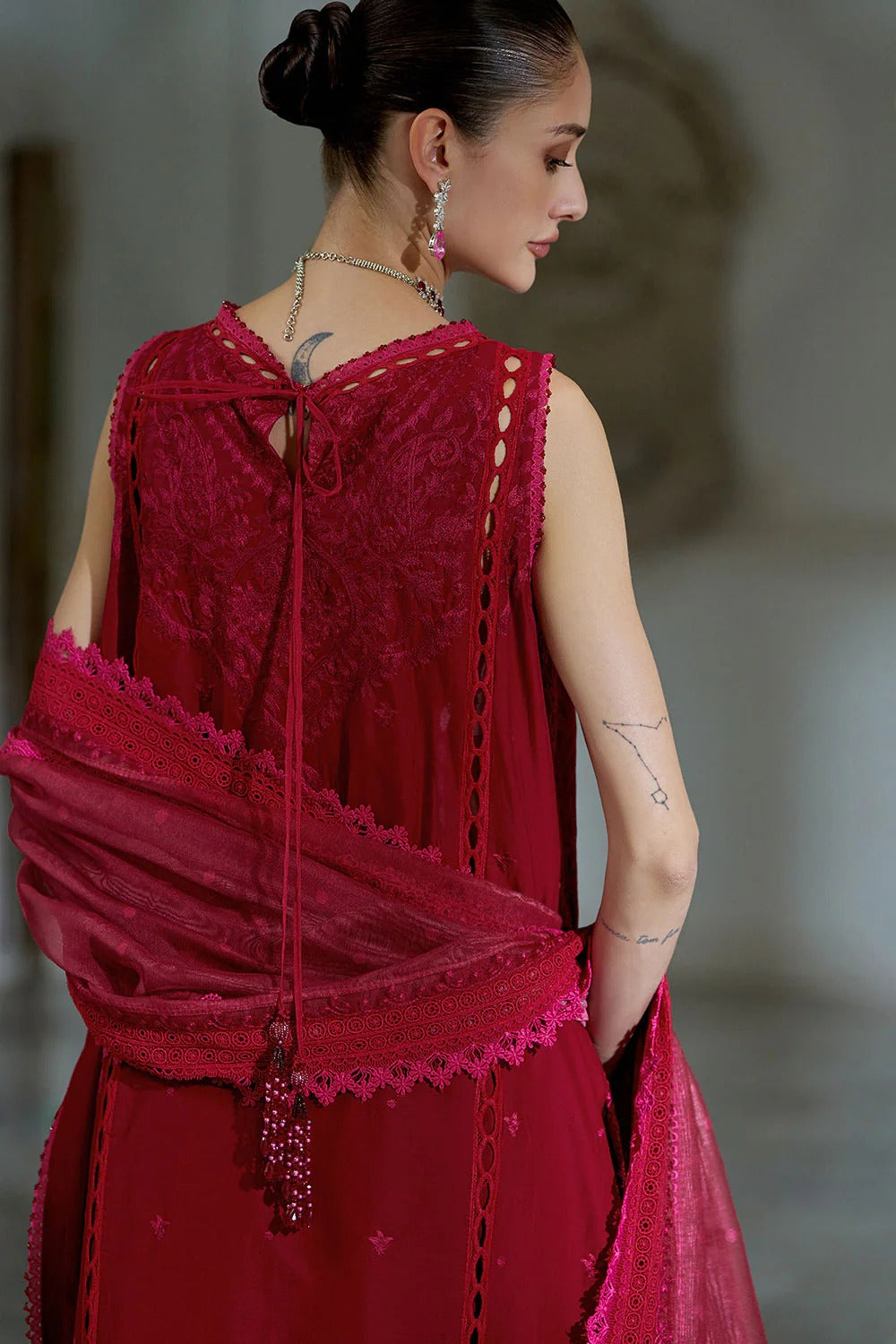 Woman wearing a red lace dress with a blurred background